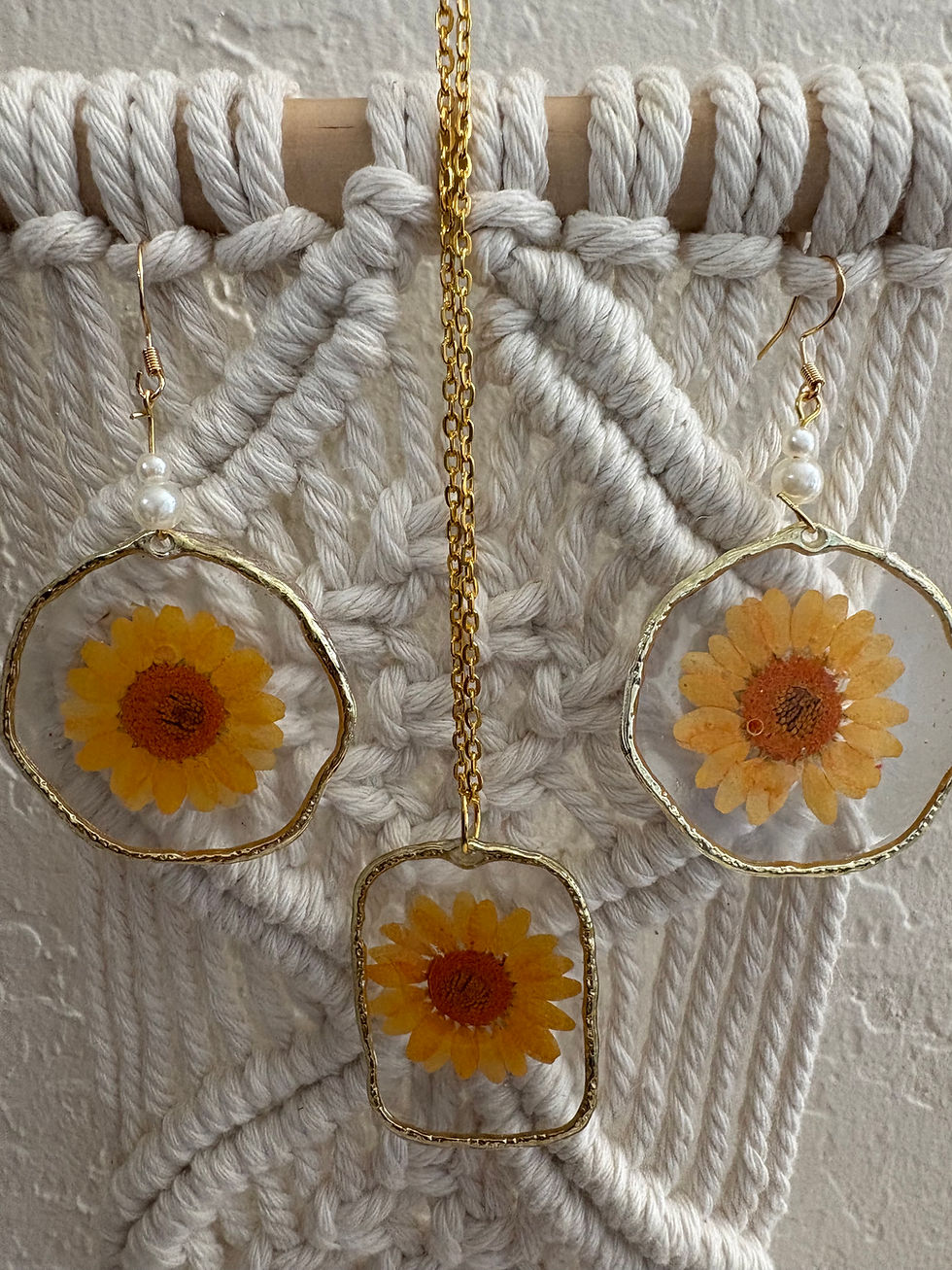 Thumbnail: Gold-framed jewelry with pressed yellow flowers