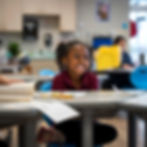 Elementary student smiling during a reading lesson in her Capstone classroom