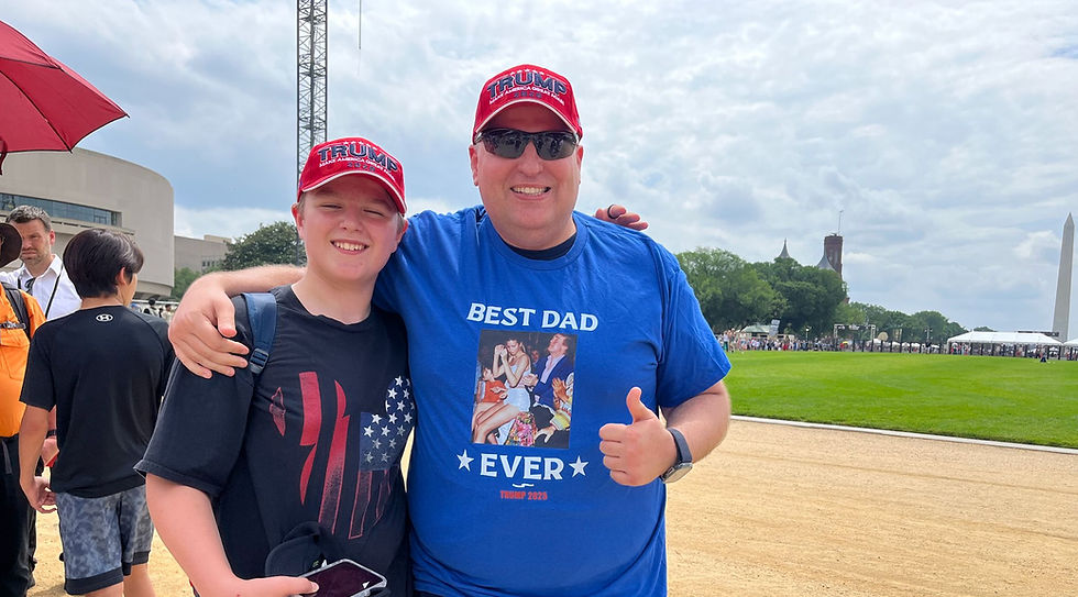 a dad and son pictured at DC military parade in Trump hats, dad wearing Trump Ivanka BEST DAD EVER shirt with thumb up