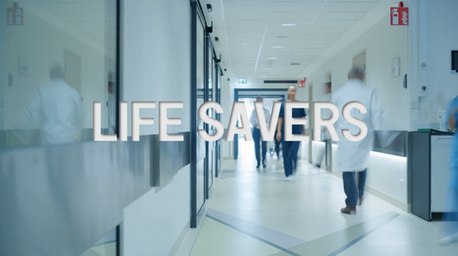 Doctors and medical staff walking through a bright hospital corridor, with the Life Savers documentary series title overlaid across the image.