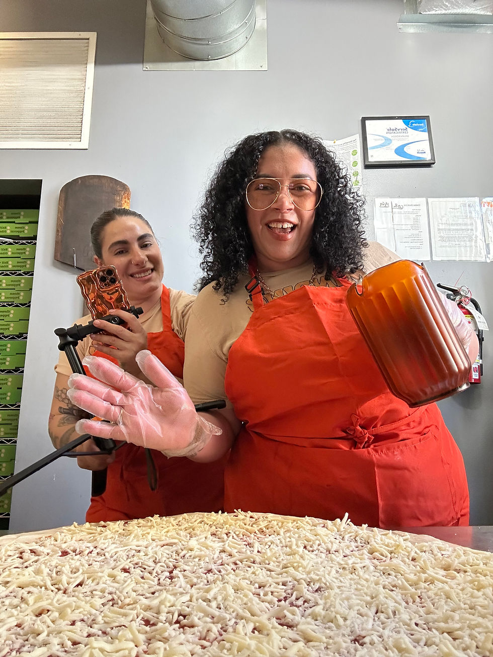 Two people in orange aprons, giant pizza in benny perettis | Marketing is like a Pizza and Most Businesses are ONLY Serving One Slice