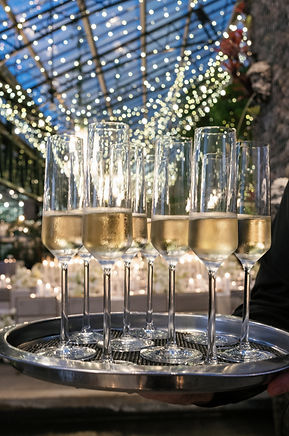Champagne toast included with Planterra weddings a luxury greenhouse venue in Michigan