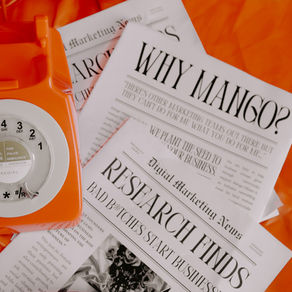 Orange rotary phone on newspapers with headlines: "WHY MANGO?" and "RESEARCH FINDS." Bright orange background adds vibrancy.