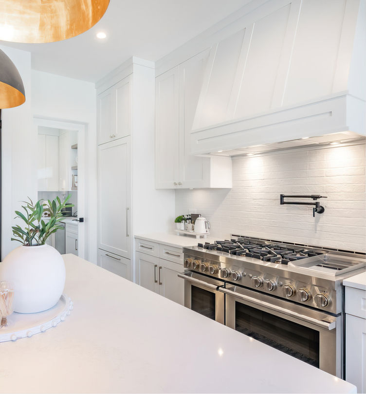 Further Customize Your Cabinetry As Shown with Coordinating Fillers and Finished Panels in the Pacific White Shaker Kitchen Cabinets.  Your or Your Carpenter Can Create Custom Wood Hoods, Appliance Doors, or Decorative Island Sides.
