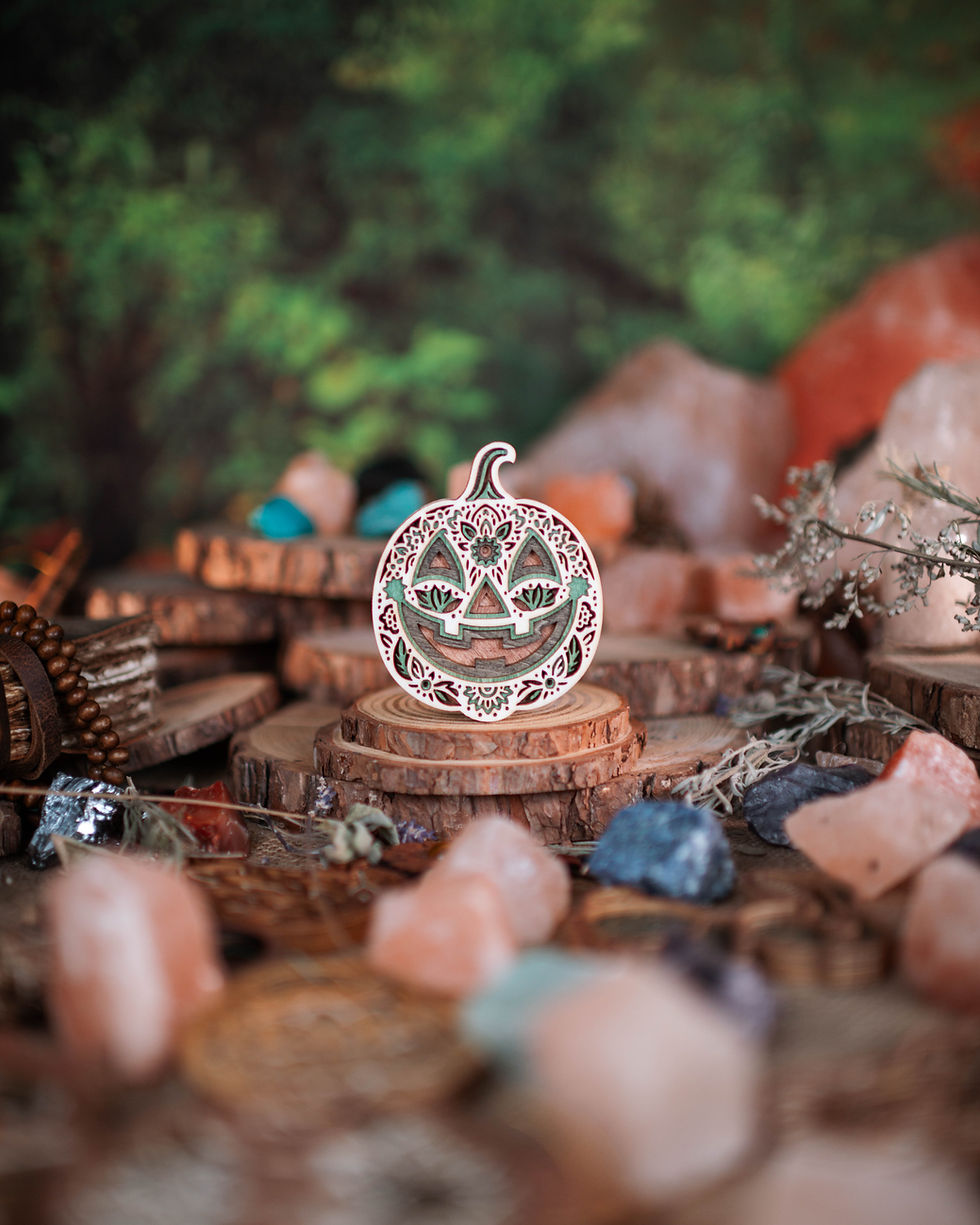 Thumbnail: Intricately carved pumpkin decoration on wood slices with stones