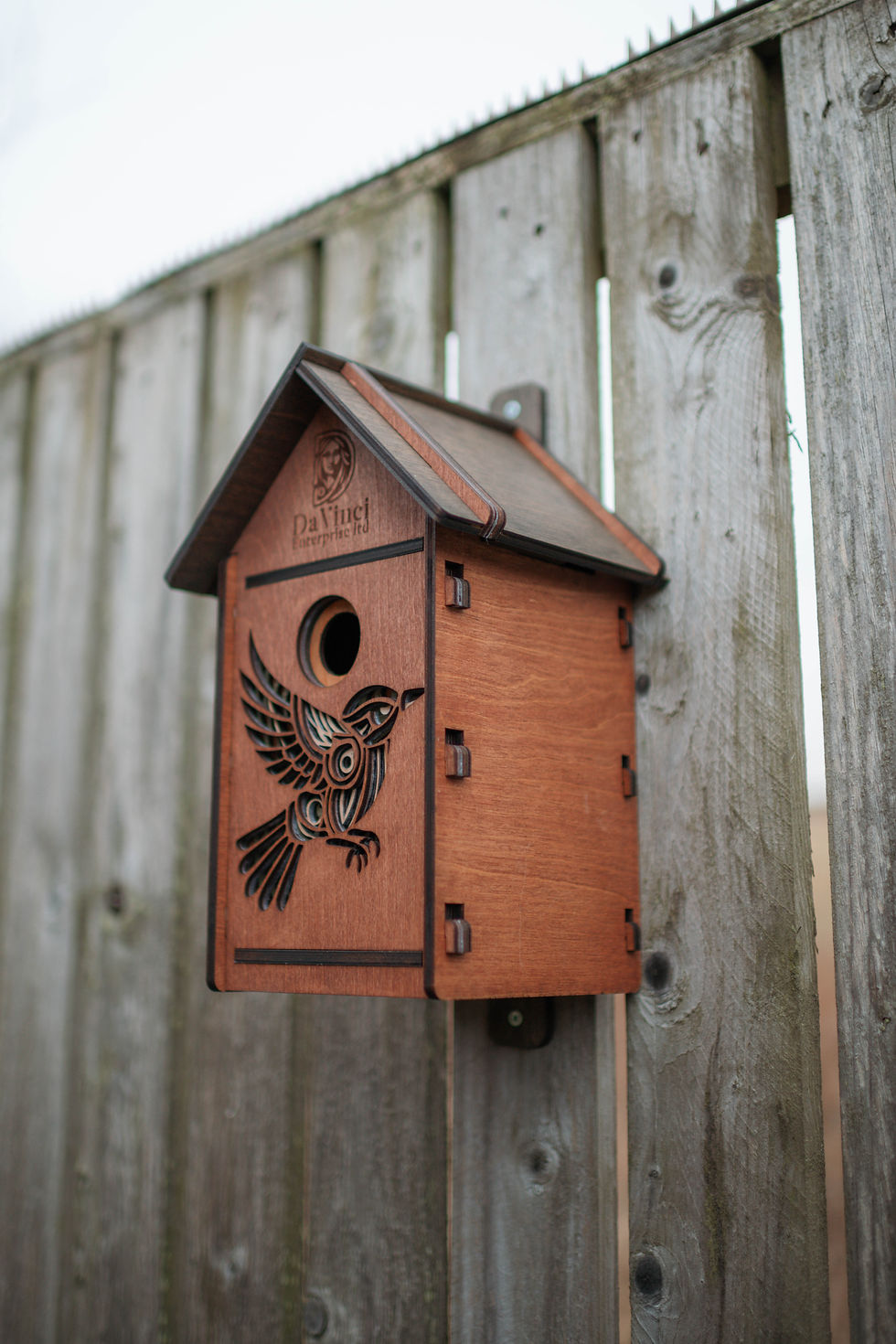 Thumbnail: Wooden birdhouse with carved bird design