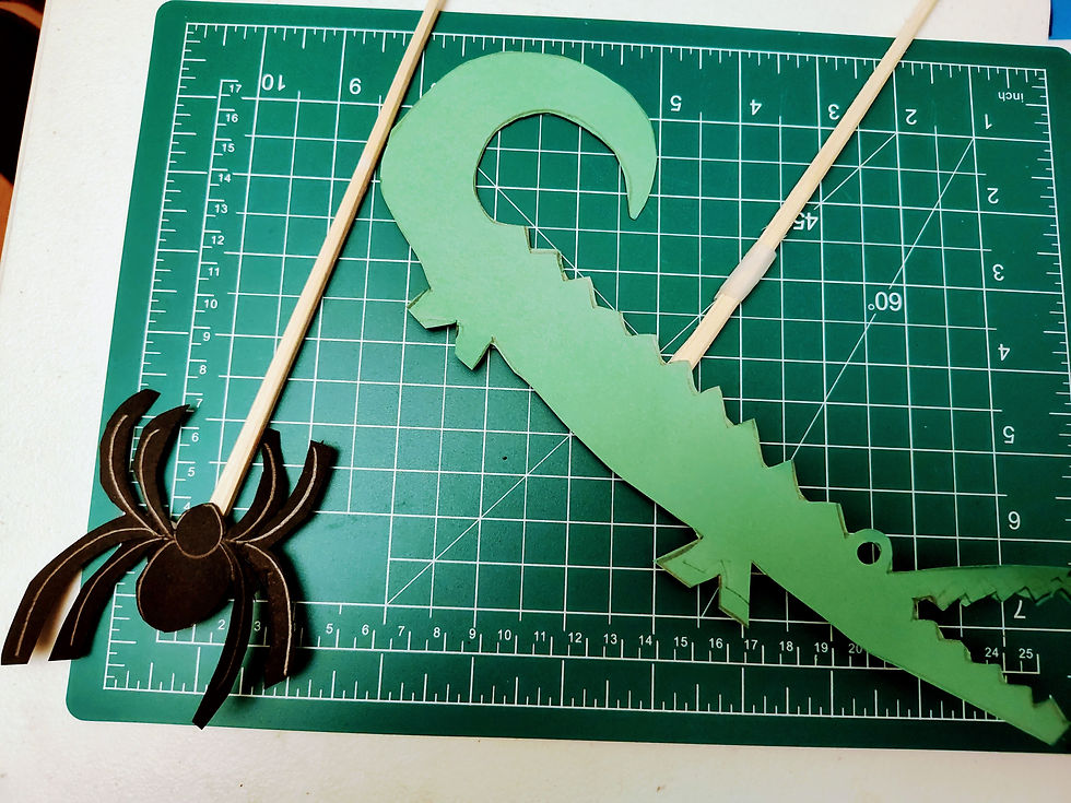 Spider and crocodile shadow puppet cut-outs.