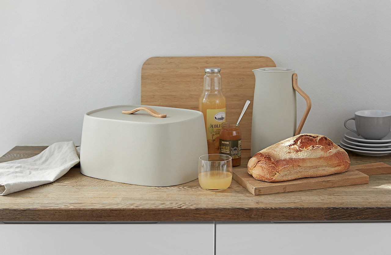 Emma Coffee Vacuum Jug & Bread Bin in soft sand with Beech Handle by Stelton, Denmark. A design classic by Holmbäck Nordenoft, known for its clean lines and innovative material combinations with steel and moulded beech wood, that lends to the Danish design tradition from the 1950s.