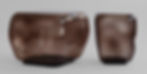 Two brown, abstract glass sculptures. The shapes are rounded and glossy, conveying an elegant, modern style.