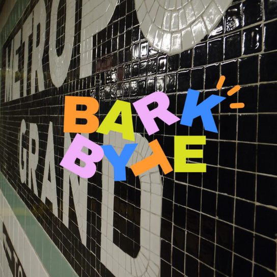 Bark Byte text with Metro Grand background on tiled wall.