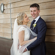 A bride and groomlaugh together at Dunmore Housr Hotel in Cork, Ireland