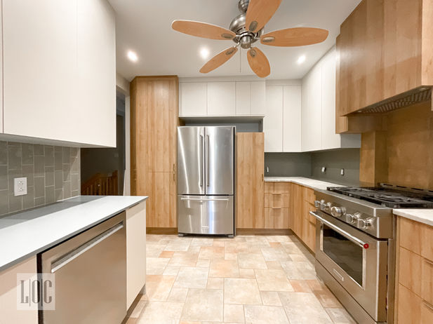 Wood and white cabinets with countertop and appliances