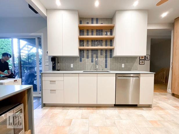 Custom cabinets with floating shelves and backsplash