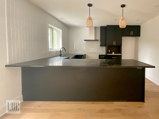 IKEA kitchen with black finish and bronze handles