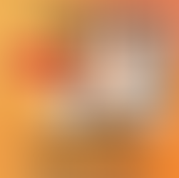 Man in white long sleeved shirt holding coffee cup while looking on a computer, he is hunched over with the hump in his back circled to identify the kyphosis in his spine. His chin is forward, shoulders are forward.