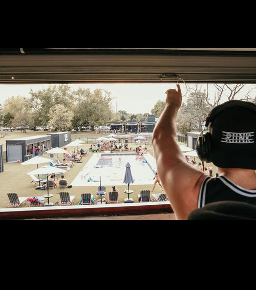 back view of DJ hand in air