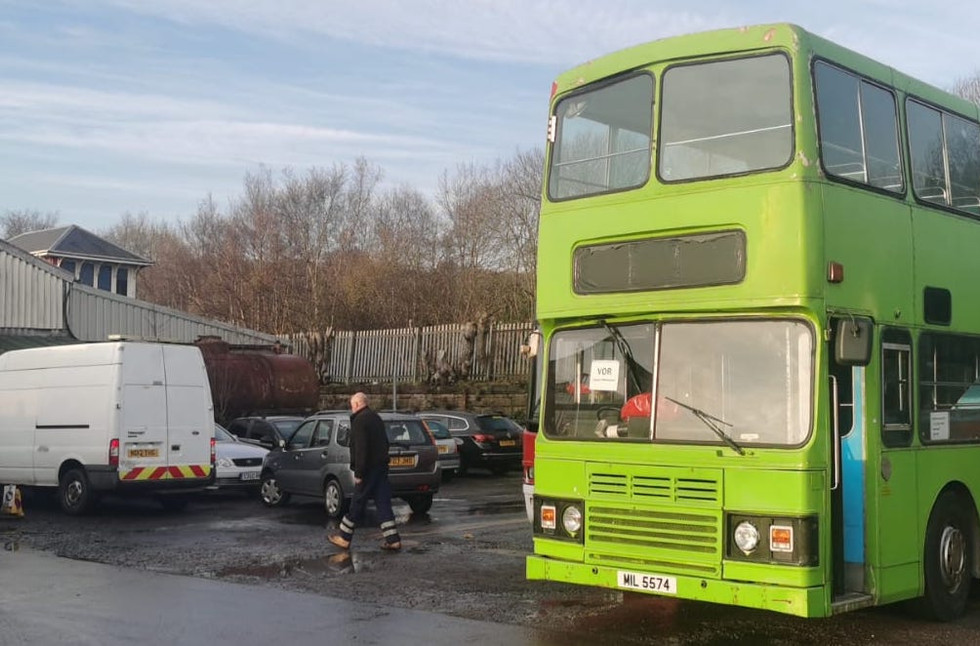 Wide shot of the green Hong Kong bus