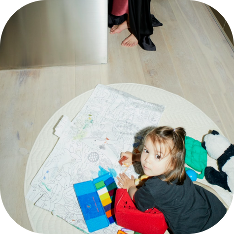 In the image, a child is engaged in play therapy, surrounded by colorful play materials such as stuffed animals and construction toys, demonstrating how play therapists use these tools to enable children to express their feelings and develop problem-solving skills. 