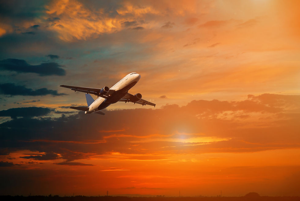Airplane taking off during sunset