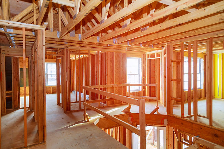 new-home-construction-with-wooden-house-frame-buil-2021-09-04-10-21-46-utc-min.jpg