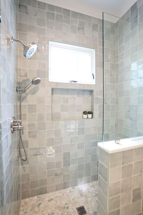 Modern shower with glass enclosure and tiled walls, contemporary design.