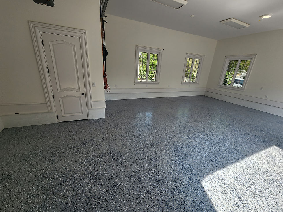 Grey speckled epoxy flooring in a bright garage space
