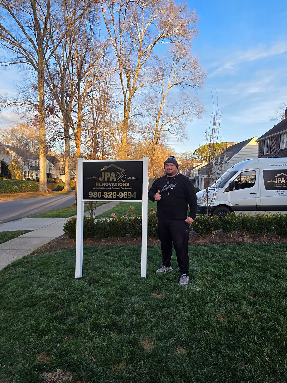 Professional standing next to a business yard sign.
