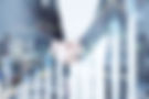 Business handshake with financial charts and city background