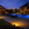 Beautifully lit house, pool, and patio at night