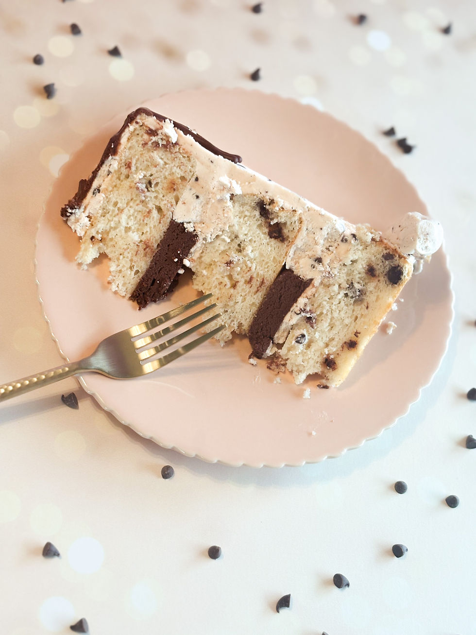 slice of chocolate chip cake with vanilla chip buttercream frosting