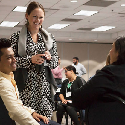 Group of leaders smiling and talking at a networking event.