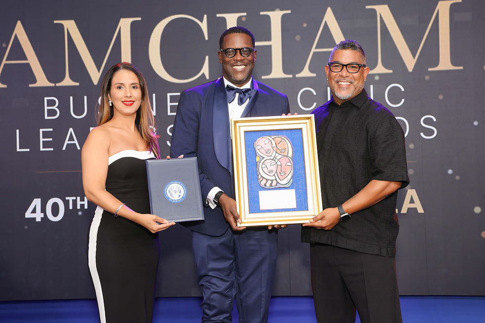 From left: Grace Kennedy Limited’s Head of Corporate Communications Suzanne Nam and American Chamber of Commerce of Jamaica (AmCham Jamaica) Vice President Stephen Price (centre) present Steve Wilson, co-manager to Sean Paul and the Sean Paul Foundation with The Good Samaritan Award for the Foundations extraordinary compassion and generosity in the aftermath of Hurricane Melissa the AmCham Business & Civic Leadership and Corporate Social Responsibility Awards and 40th Anniversary Gala on Wednesday, May 27, 2026.