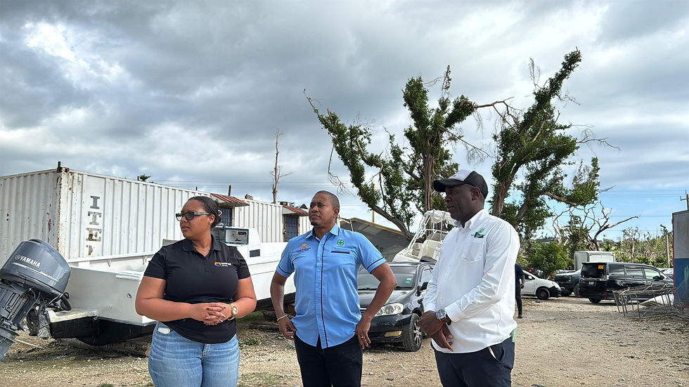 United Way of Jamaica CEO Kerry-Lee Lynch (centre) and Minister of Agriculture, Fisheries and Mining Floyd Green listens as Jamaica Agricultural Society CEO Derron Grant detail the particulars of the first distribution from the UWJ Hurricane Melissa Restoration and Rehabilitation Fund on Wednesday, February 25, at the Bluefields Bay Fishing Village.