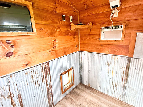 Interior photo of theSallie Ann Jarrett Cabin showing the dog door, AC, radio, and overall spaciousness 