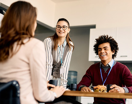 Three people seated around a table discussing support and planning