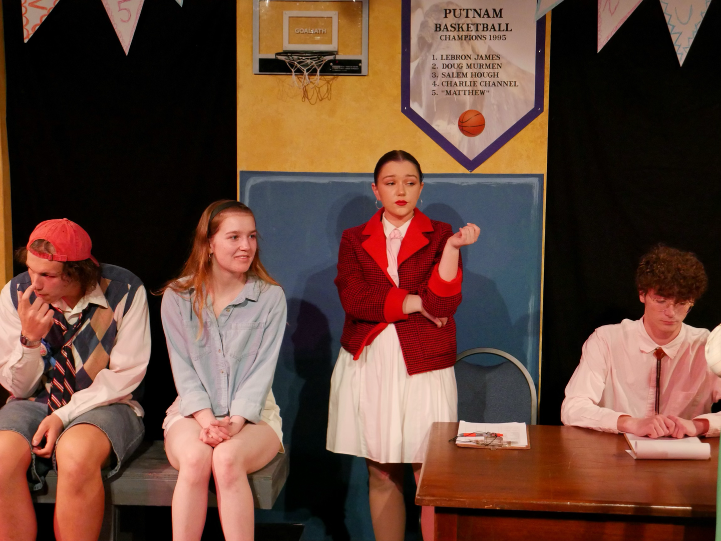 (L to R) Jonny Bashford as Chip, Audience Speller, Edie Roth as Rona, Joey Richards as Panch