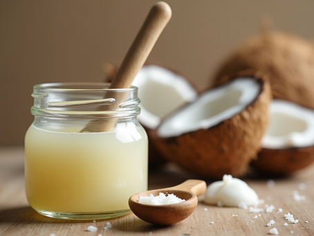 Close-up view of a small jar of coconut oil with a wooden spoon on a natural wooden surface