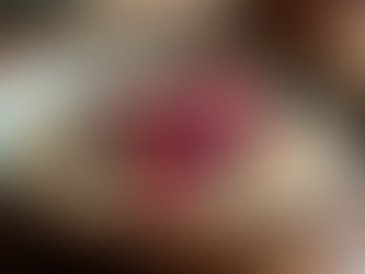 Close-up view of a bowl of cooked millet porridge topped with fresh berries and nuts