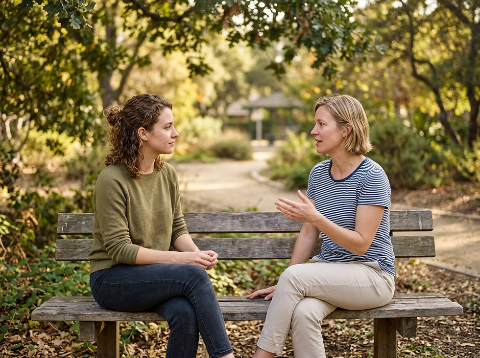 Eye-level view of two friends talking on a park bench