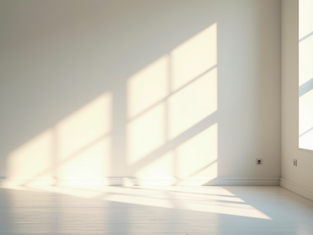 Eye-level view of a clear, empty room with sunlight streaming through a window