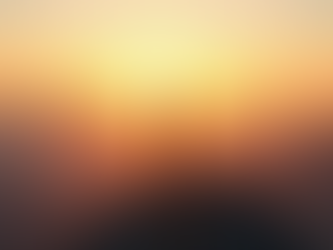 Eye-level view of a person standing on a mountain peak at sunrise, looking at the horizon