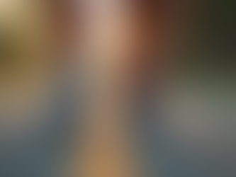 Eye-level view of a person tying running shoes on a quiet morning street