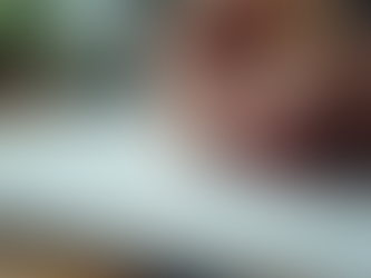 Eye-level view of a person writing goals and tracking progress on a notebook