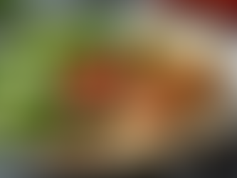 Eye-level view of a balanced plate with fresh vegetables, whole grains, and lean protein