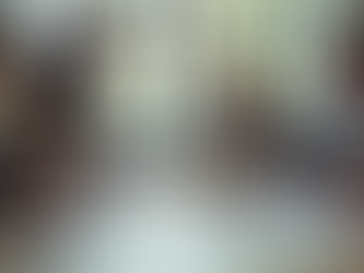 Eye-level view of a diverse team collaborating around a table with laptops and notes