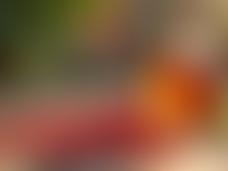 Close-up view of rosehip seeds and oil bottle on wooden surface