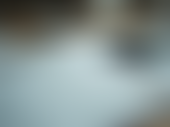 Close-up view of scattered notes and a smartphone on a cluttered desk