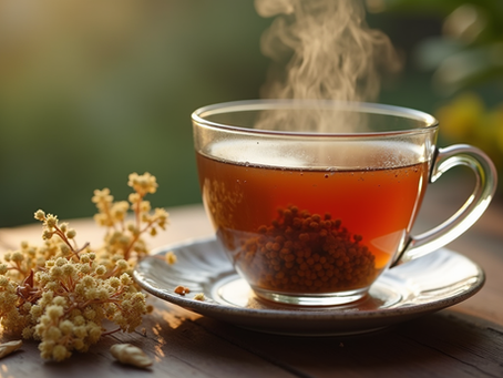 Close-up view of a steaming cup of valerian tea on a wooden table with dried valerian roots beside it