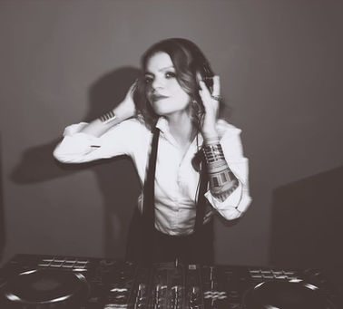 DJ Junglecat, also known as Jyotsna Ramani, performing an electronic and house DJ set at a club or nightlife event.