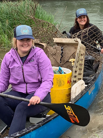 People serving teir community byparticipating in the river clean up